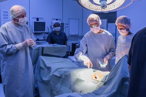 Healthcare staff in a hospital environment performing a surgery